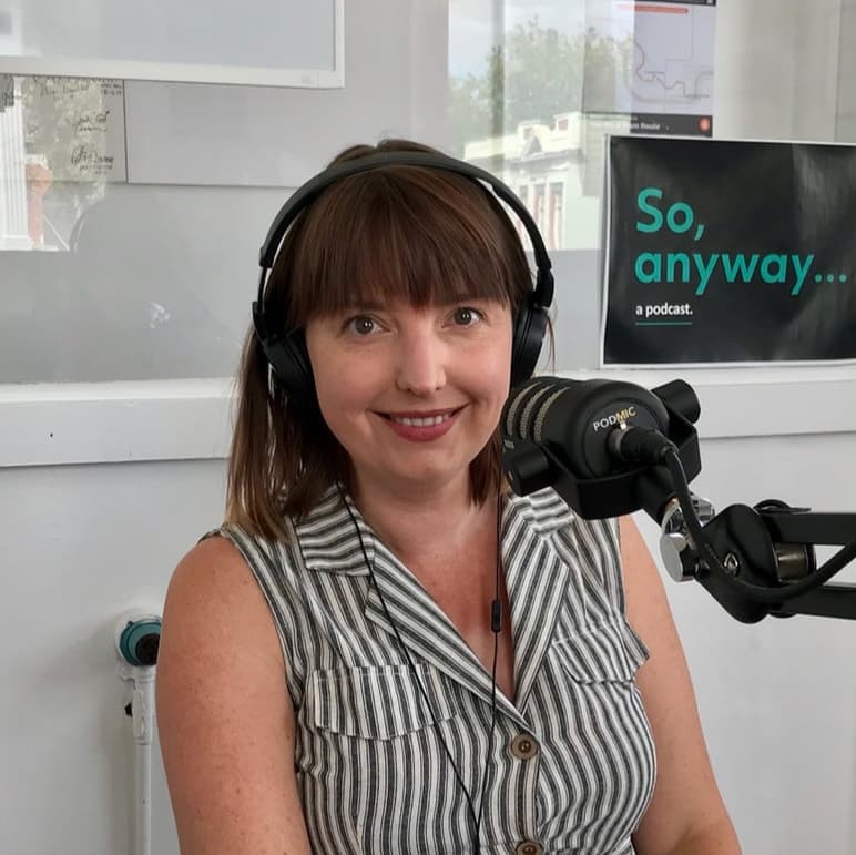 Sara Fredrickson, owner of Mindzye Fashions, wearing headphones during a podcast recording